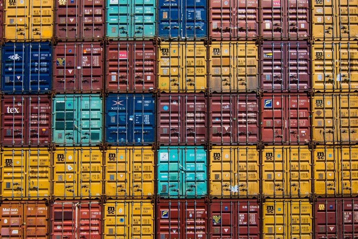 Stacked shipping containers representing international trade volume