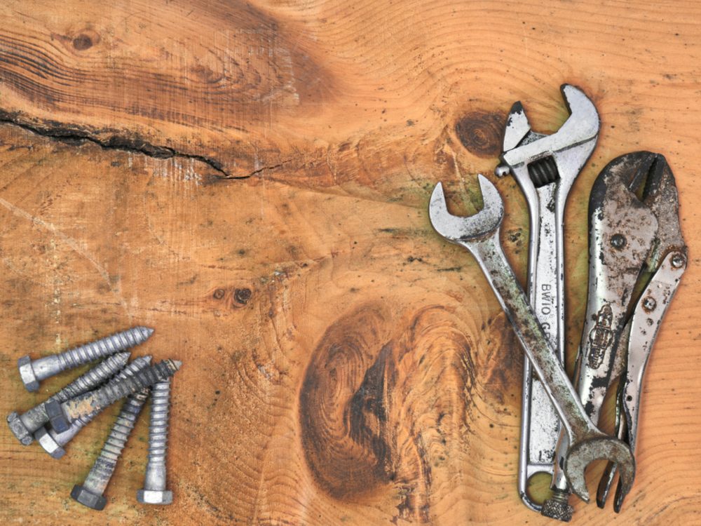Spanners and fasteners laid out on a workbench
